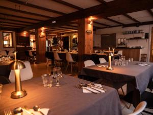 a dining room with two tables and chairs and tablesearcher at Hotel Chalet du Crey in Valmorel +62 photos