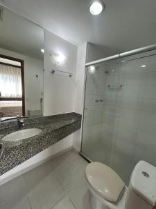 a bathroom with a toilet and a sink and a shower at Hotel Mercu Paraíso Benefência c garagem e cozinha 1606 in Sao Paulo