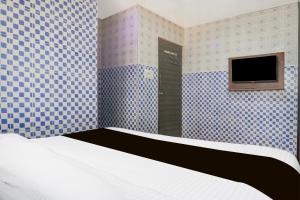 Ένα ή περισσότερα κρεβάτια σε δωμάτιο στο Hotel O Corporate Stay