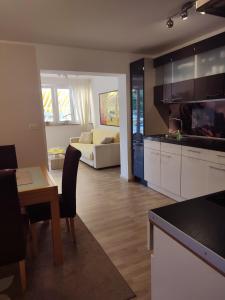 a kitchen and living room with a table and a couch at Apartment Gio in Novigrad Istria