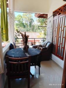 a table in a living room with a couch and a chair at Zen Heaven Villa Mirissa south Kamburugamuwa in Nikawatawana