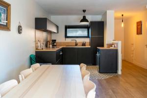 a kitchen with a table and chairs in a room at Maison de vacances Oceanides in Capbreton +15 photos