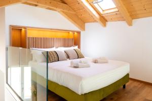 a bedroom with a large bed with white sheets at Marmori Suites Cagliari in Cagliari