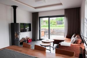 a living room with a couch and a table at Chalupa Nadohled in Červený Potok