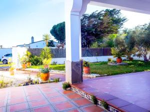 a patio with potted plants in a yard at Chalet Piscina Privada Zona Vallada con Barbacoa in Roche