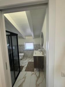 a bathroom with a sink and a toilet at Apartment with Jacuzzi near Como Milano FREE PARKING in Mozzate +15 photos