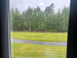 a view of a field from a window at Rentalux Apartment Rooms in Timrå