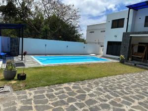 a swimming pool in the backyard of a house at AA villa in Calodyne