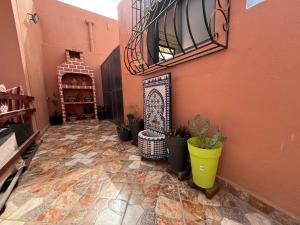 a hallway with potted plants and a staircase in a building at Dream House Sidi Ifni in Sidi Ifni