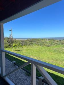 a view of the ocean from the porch of a house at Cabañas San Jorge N4 in Bella Vista