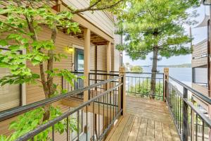 a home with a deck with a view of the water at Boat Slip and Pool Access at Lake Ozark Condo! in Lake Ozark