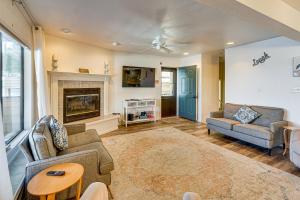 a living room with two couches and a fireplace at Boat Slip and Pool Access at Lake Ozark Condo! in Lake Ozark