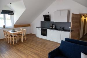 a living room with a kitchen and a table and chairs at Gasthaus Hansch in Egling