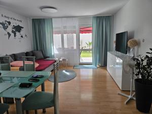a living room with a couch and a table at New Apartment mit Terrasse in Hannover
