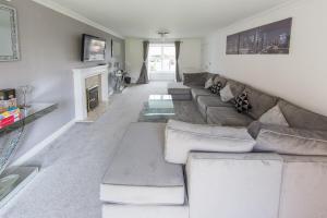 a living room with a couch and a fireplace at Family & Group 5 Bedroom House by Heath Park in Cardiff