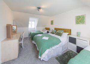 a bedroom with two beds and a desk and a mirror at Family & Group 5 Bedroom House by Heath Park in Cardiff