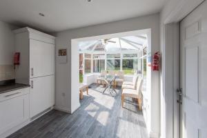 a kitchen and dining room with a table and chairs at Family & Group 5 Bedroom House by Heath Park in Cardiff