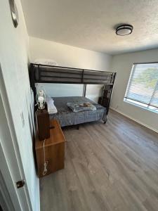 a bedroom with a bunk bed and a wooden floor at 245 Head St in Camp Verde
