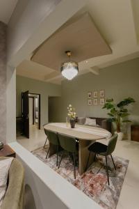 a dining room with a table and chairs at Omnia By Alhanney in Guwahati