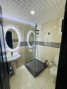 a bathroom with a shower and a toilet and a sink at appartement luxueux à Rabat in Sale +19 photos