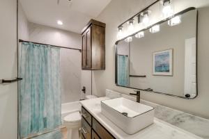 a bathroom with a sink and a toilet and a mirror at 7 Mi to AFB Central and Modern San Angelo Home in San Angelo +16 photos