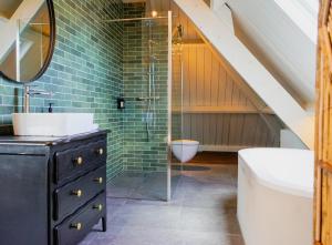 a bathroom with a sink and a glass shower at Villa la Vida in Tilburg
