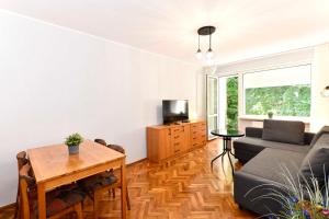 a living room with a couch and a table at Amber room in Sopot