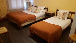 a hotel room with two beds in a room at Hôtel JurJura in Dole