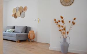a living room with a couch and a vase with flowers at Casa Miradouro das Beatas in Elvas +6 photos