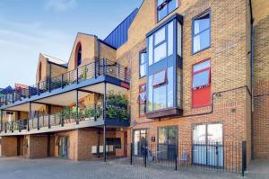 an exterior view of a brick building with balconies at Renovated 1B Studio Apartment w Balcony in Central Brixton in London
