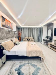 a bedroom with a large bed and a living room at Crystal Luxury Studio At Kass 1000 in Accra