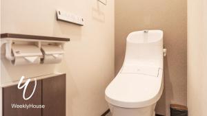 a bathroom with a white toilet in a room at WeeklyHouse BiwakoOtsu in Otsu +18 photos