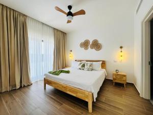a bedroom with a bed and a ceiling fan at Cana Cove in Punta Cana +74 photos