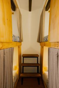 a bedroom with two bunk beds and a table at The Cranky Croc Hostel in Bogotá