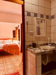 En eller flere senge i et værelse på Vila Sossego