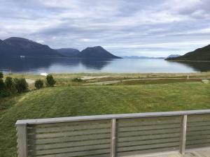 a view of a body of water with a fence at Tromsø idyllic cabin in Tromsø