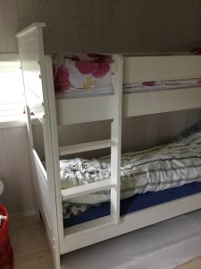 a white bunk bed with a ladder next to it at Tromsø idyllic cabin in Tromsø