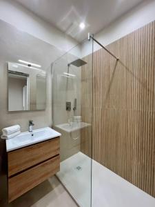 a bathroom with a glass shower and a sink at Athenèa Smart Rooms - Atenea Collection in Agrigento +66 photos