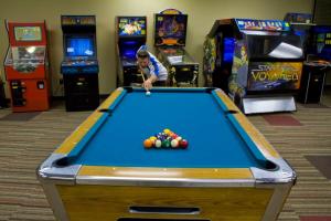 a man playing pool in a game room at Wyndham Fairfield Glade 1BR King Suite Apartment with Resort Access in Fairfield Glade
