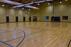 an empty gymnasium with a wooden basketball court at Wyndham Fairfield Glade 1BR King Suite Apartment with Resort Access in Fairfield Glade