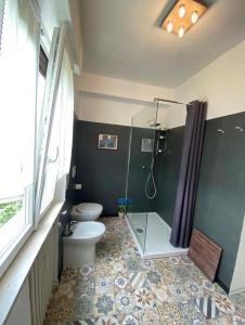 a bathroom with a toilet and a glass shower at L'Ultimo Piano b&b Forlì in Forlì +13 photos