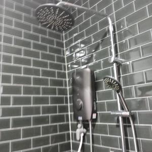 a brick wall with a hair dryer and a hair brush at Raniah homestay in Kuching +40 photos