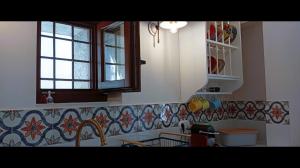 a kitchen with a sink and a window and a counter at Armiriki Seafront House in Afissos