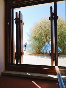 a window with a view of a person on a skateboard at Armiriki Seafront House in Afissos +36 photos