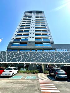 a large building with cars parked in a parking lot at (106) Studio Inesquecível em espaço Moderno in Vinhais