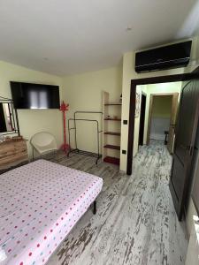 a bedroom with a bed and a tv on the wall at El RINCONCITO in Mahora