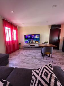 a living room with a table and a tv at El RINCONCITO in Mahora