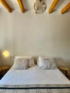 a bedroom with a bed with two pillows on it at Casa luz in Viñuela