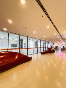 a large room with a large red couch in a building at Luxury Summer Suites KLCC By LEXA Stay in Kuala Lumpur