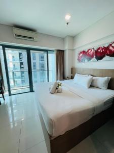 a bedroom with a large bed with two teddy bears on it at Luxury Summer Suites KLCC By LEXA Stay in Kuala Lumpur